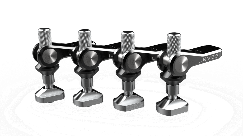 FoilMount-09 - Four Pack A.44 Four metallic, mechanical components with knobs and levers are arranged in a row on a white background. Showcasing precision and innovation, these pieces highlight Industrial Design NZ expertise, with "LEVES" printed on one lever.